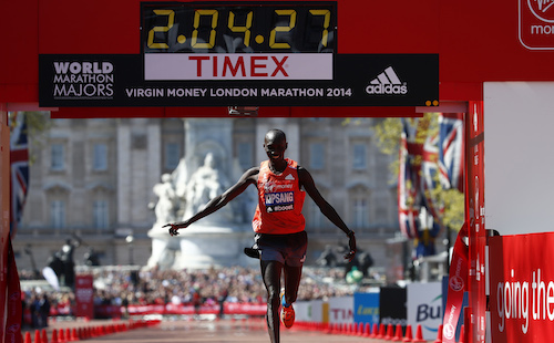 Wilson Kipsang of Kenya celebrates as he crosses the finish line to win the men's Elite London Marathon